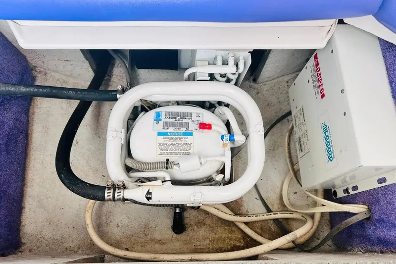 Slide: The Image of 1996 Baja .38 Special boat on trailer, featuring sleek white hull and blue stripe. - 96