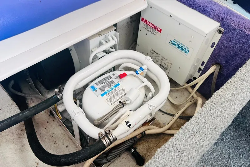 Slide: The Image of 1996 Baja .38 Special boat on a trailer, parked on gravel near a metal building. - 97