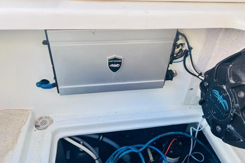 Slide: The Image of Engine compartment of a 1996 Baja .38 Special boat, featuring mechanical components and wiring. - 99