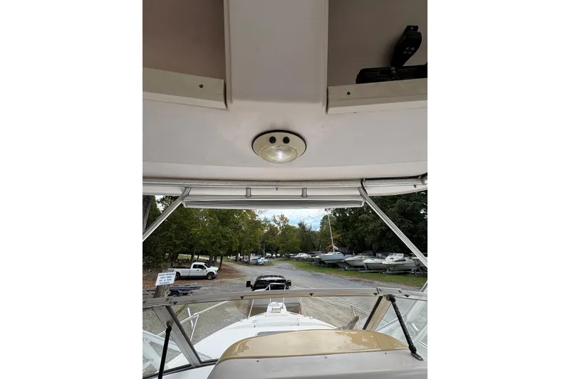Slide: The Image of 2001 Grady-White Express 265 boat interior view with overhead light and windshield. - 11