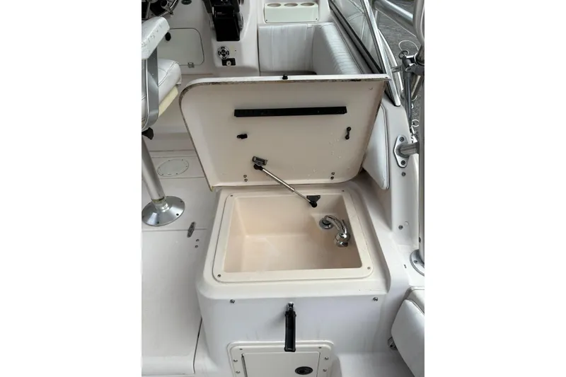 Slide: The Image of 2001 Grady-White Express 265 boat interior with open storage compartment and seating. - 14