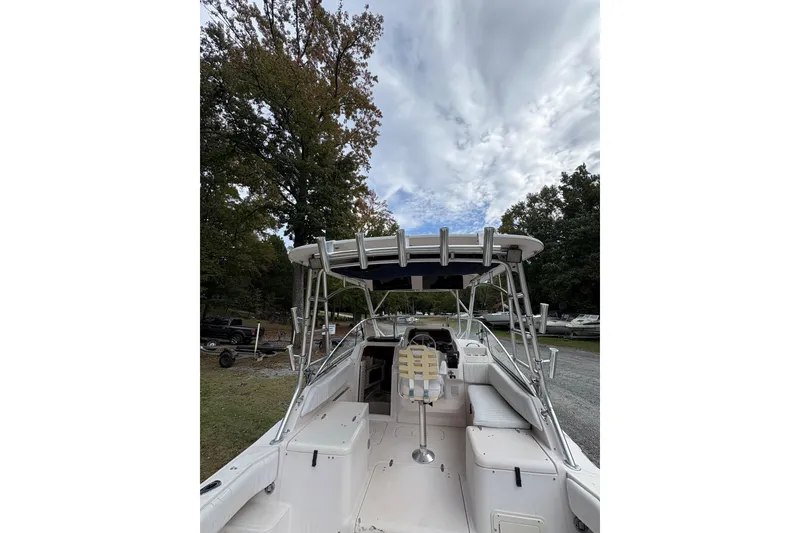 Slide: The Image of 2001 Grady-White Express 265 boat with seating, docked outdoors under cloudy sky. - 16
