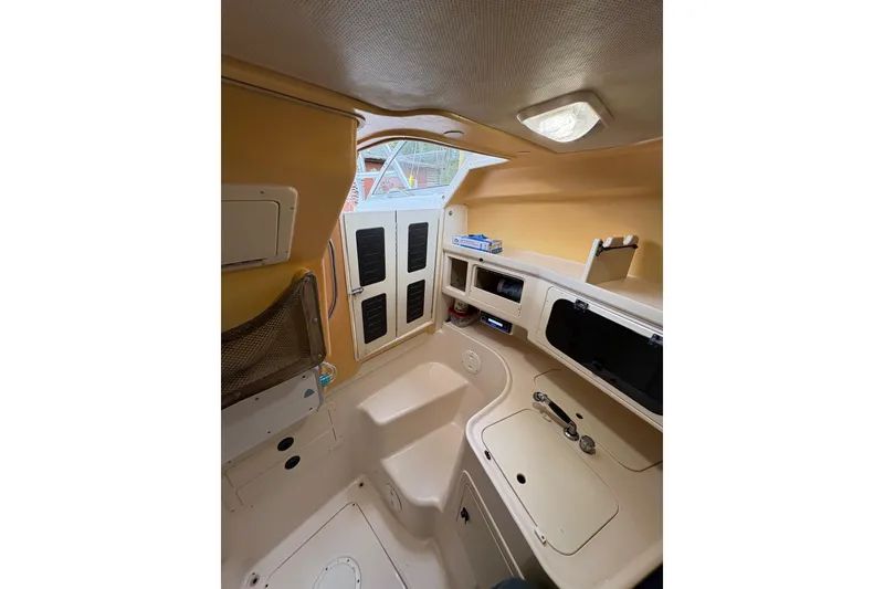 Slide: The Image of Interior cabin of 2001 Grady-White Express 265 boat, featuring storage and compact design. - 20