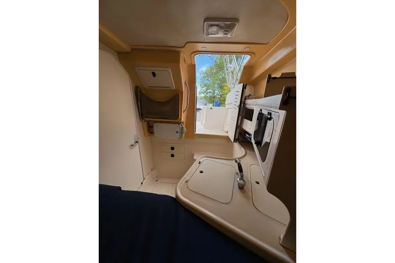 Slide: The Image of 2001 Grady-White Express 265 cabin interior with storage compartments and seating area. - 23