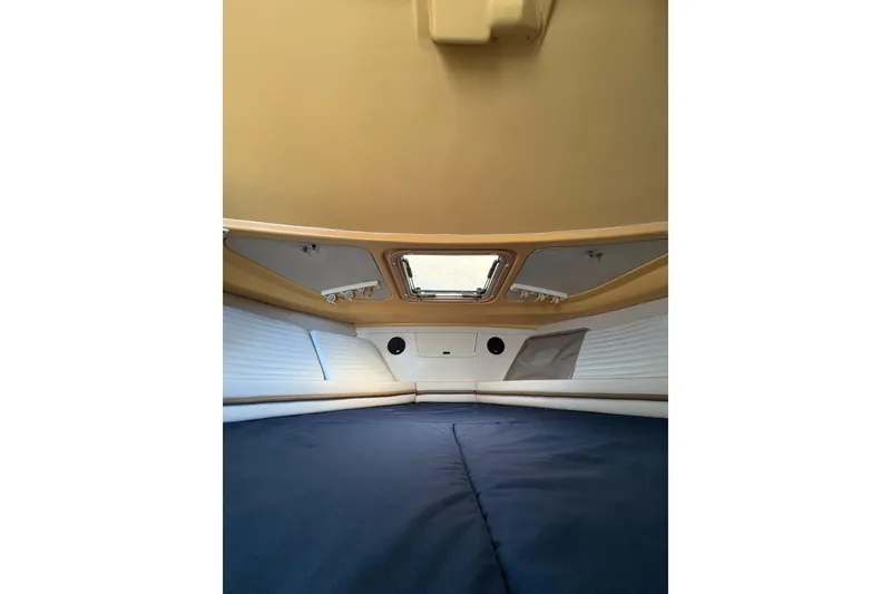 Slide: The Image of Interior cabin of 2001 Grady-White Express 265 boat, featuring a cozy sleeping area. - 24