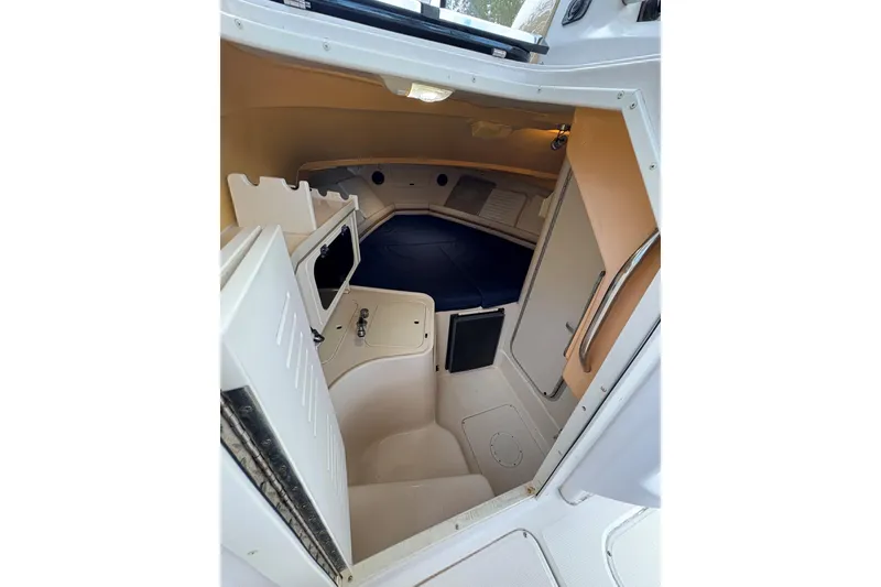 Slide: The Image of 2001 Grady-White Express 265 cabin interior with seating and storage. - 26