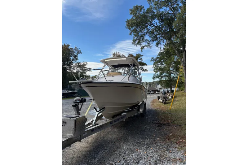 Slide: The Image of 2001 Grady-White Express 265 boat on trailer, parked outdoors under blue sky. - 3