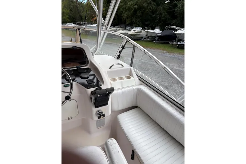 Slide: The Image of 2001 Grady-White Express 265 boat interior with steering console and seating area. - 31