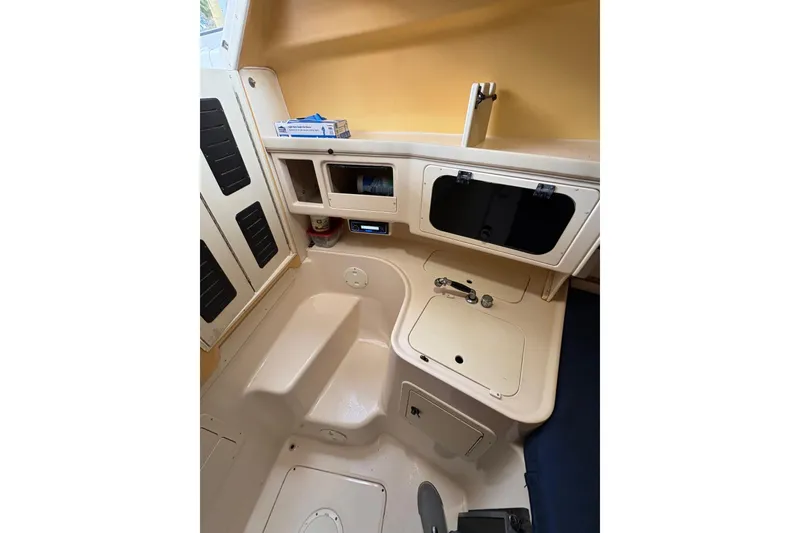 Slide: The Image of 2001 Grady-White Express 265 cabin interior with storage and sink. - 38