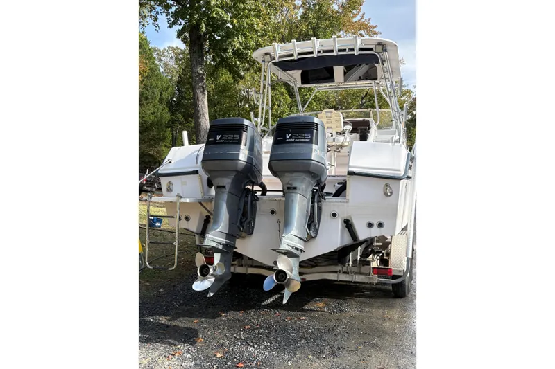 Slide: The Image of 2001 Grady-White Express 265 boat with dual V225 outboard engines, parked outdoors. - 41