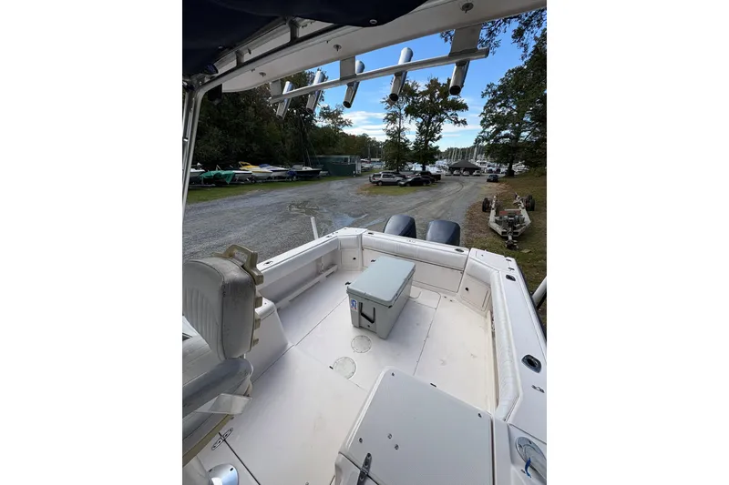 Slide: The Image of 2001 Grady-White Express 265 boat interior at a marina with parked boats. - 42