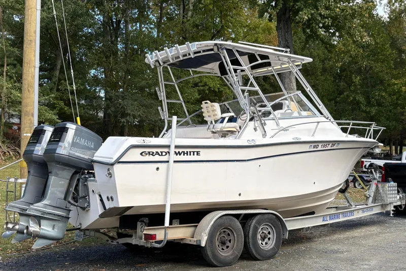 Slide: The Image of 2001 Grady-White Express 265 boat on trailer with Yamaha engines, parked outdoors. - 5