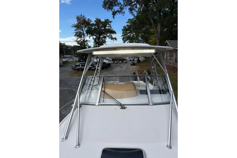 Slide: The Image of 2001 Grady-White Express 265 boat with T-top and windshield, docked outdoors. - 7