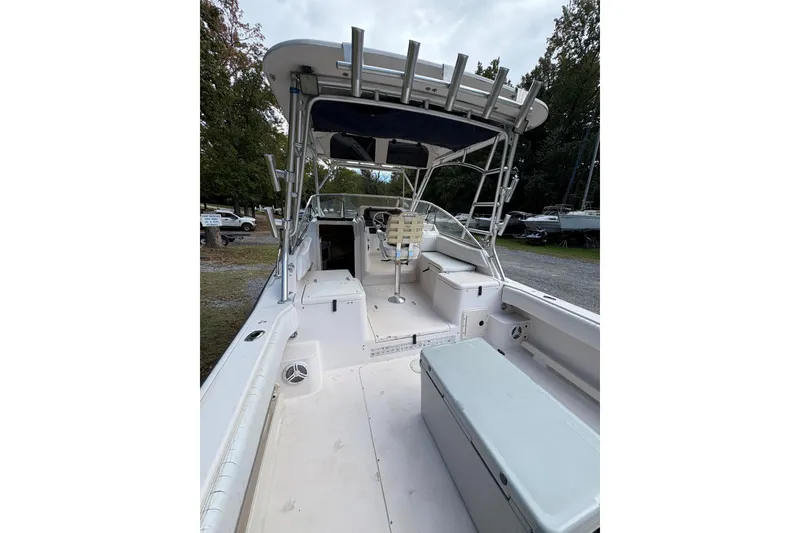 Slide: The Image of 2001 Grady-White Express 265 boat interior with seating and storage, docked outdoors. - 8
