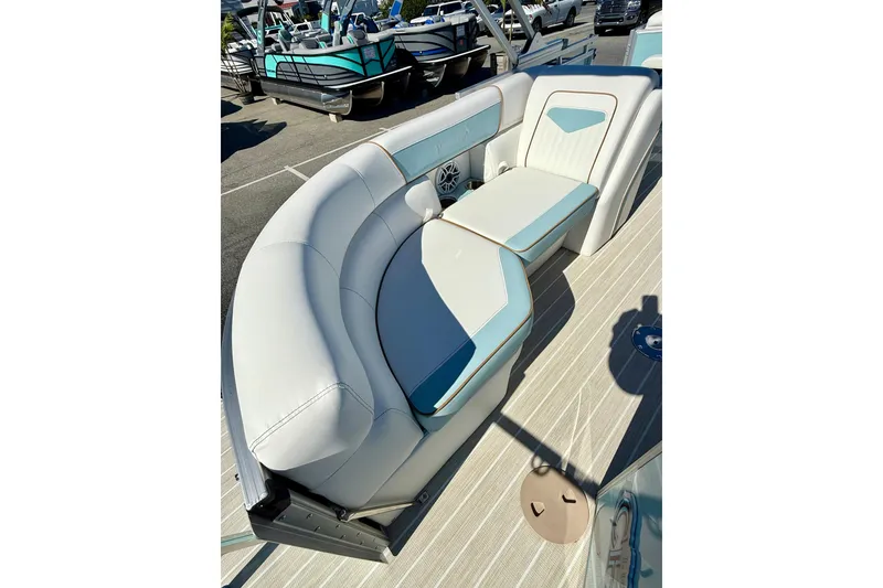 Slide: The Image of 2026 Berkshire 22RFX CHILL boat interior with white and blue seating on a sunny day. - 10