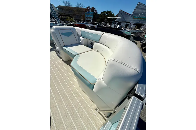 Slide: The Image of Luxurious seating on 2026 Berkshire 22RFX CHILL pontoon boat, featuring elegant white and blue upholstery. - 12