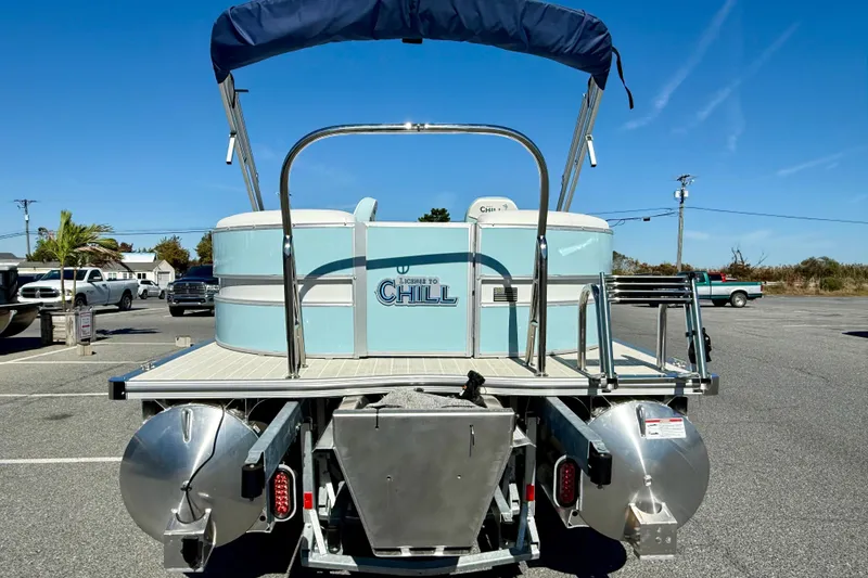 Slide: The Image of 2026 Berkshire 22RFX CHILL pontoon boat with blue canopy in parking lot. - 21