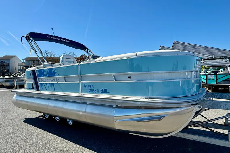Slide: The Image of 2026 Berkshire 22RFX CHILL pontoon boat with blue exterior, docked under clear sky. - 4