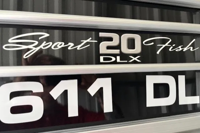 Slide: The Image of 2023 Sun Tracker SportFish 20 DLX logo on boat exterior. - 12