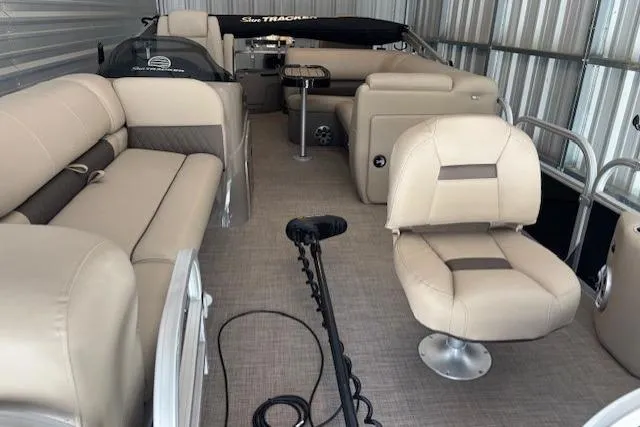 Slide: The Image of 2023 Sun Tracker SportFish 20 DLX pontoon boat with beige seating and modern interior. - 3