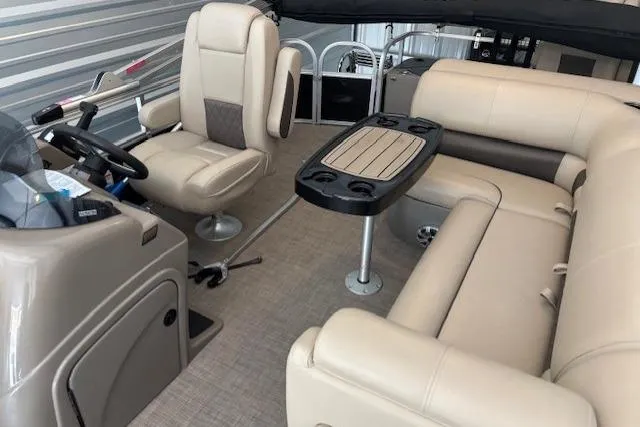 Slide: The Image of 2023 Sun Tracker SportFish 20 DLX interior with beige seating and table. - 4