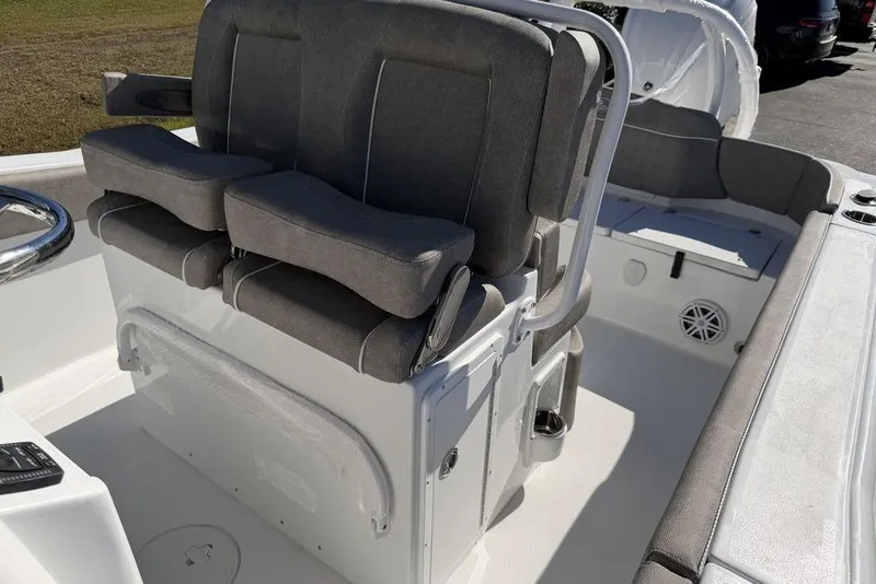 Slide: The Image of 2026 Sea Hunt Ultra 245 SE boat interior with cushioned seating and steering console. - 11