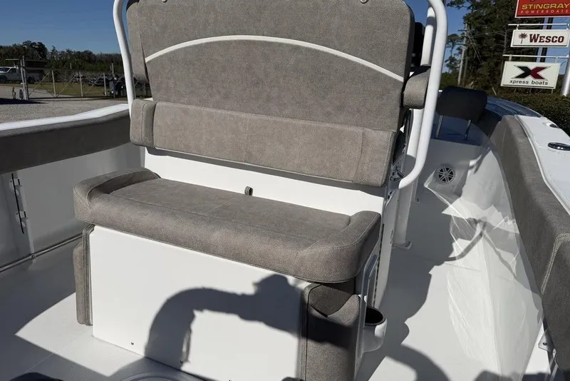 Slide: The Image of 2026 Sea Hunt Ultra 245 SE boat interior with cushioned seating and white deck. - 16