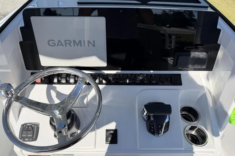 Slide: The Image of Control panel of 2026 Sea Hunt Ultra 245 SE with Garmin display and steering wheel. - 18