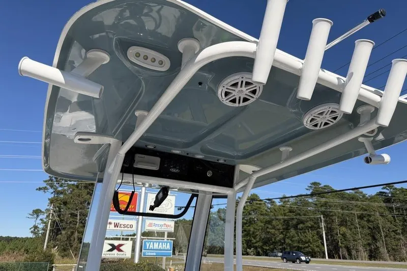 Slide: The Image of 2026 Sea Hunt Ultra 245 SE boat T-top with rod holders and speakers. - 19