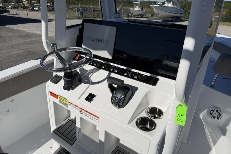 Slide: The Image of 2026 Sea Hunt Ultra 245 SE boat console with Garmin display and steering wheel. - 20