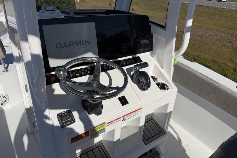 Slide: The Image of 2026 Sea Hunt Ultra 245 SE boat console with Garmin navigation system and steering wheel. - 21