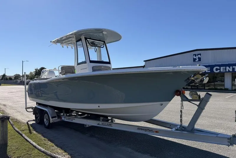 Slide: The Image of 2026 Sea Hunt Ultra 245 SE boat on trailer, parked outdoors. - 3