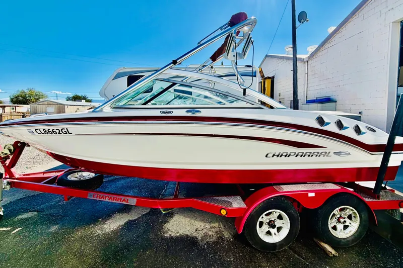 Slide: The Image of 2013 Chaparral 206 SSi boat on red trailer, parked outdoors. - 3