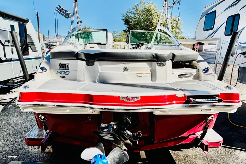 Slide: The Image of 2013 Chaparral 206 SSi boat, rear view, parked between RVs. - 5
