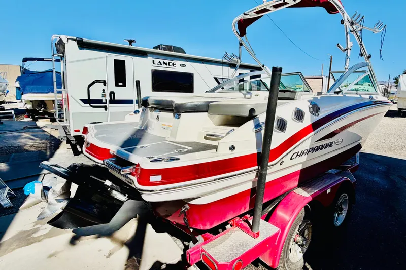 Slide: The Image of 2013 Chaparral 206 SSi boat on a trailer, parked near a camper. - 7