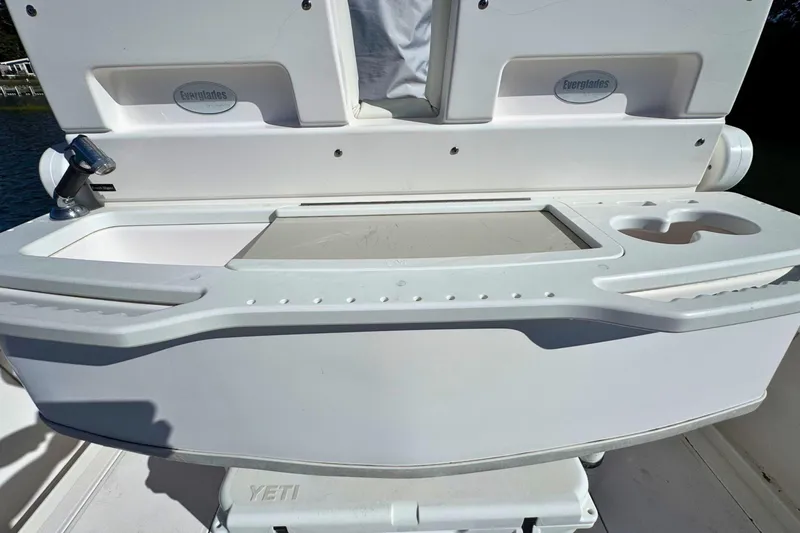 Slide: The Image of 2015 Everglades 255 Center Console boat with a built-in sink and storage area. - 13