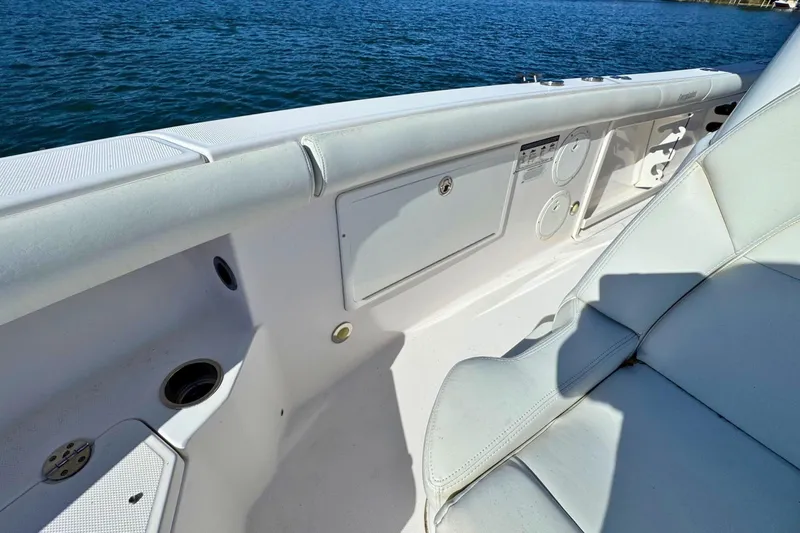 Slide: The Image of 2015 Everglades 255 Center Console boat interior with white seating and storage compartments. - 20