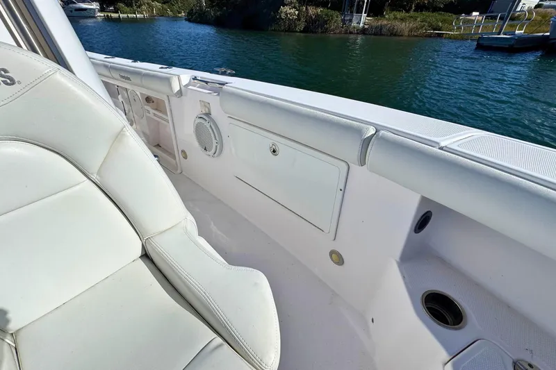 Slide: The Image of 2015 Everglades 255 Center Console boat interior with white seating and storage compartments. - 22