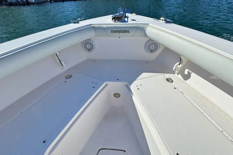 Slide: The Image of 2015 Everglades 255 Center Console boat interior with seating and speakers on calm water. - 23