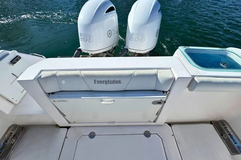 Slide: The Image of 2015 Everglades 255 Center Console boat with twin Yamaha 200 engines on water. - 9