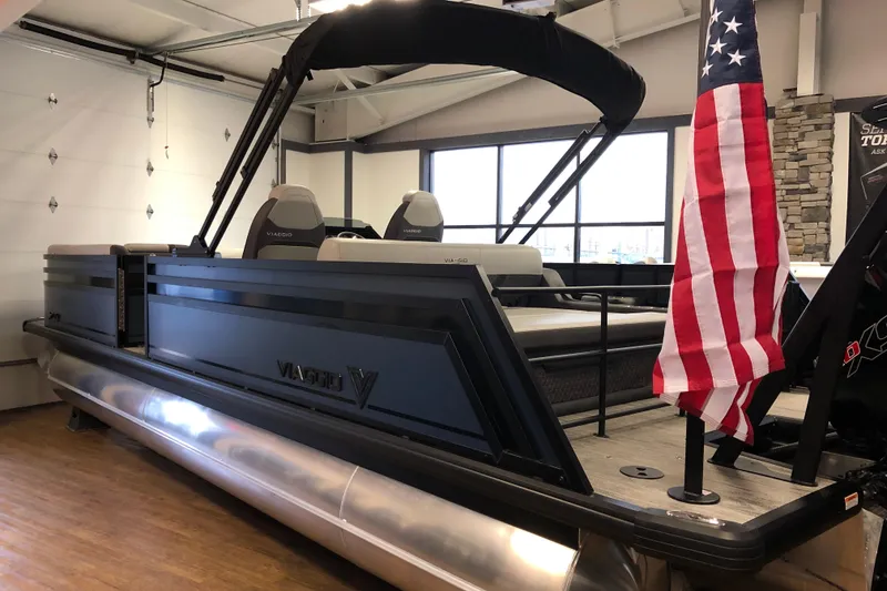 The Image of 2026 Viaggio Z24S pontoon boat with American flag in showroom. - 2
