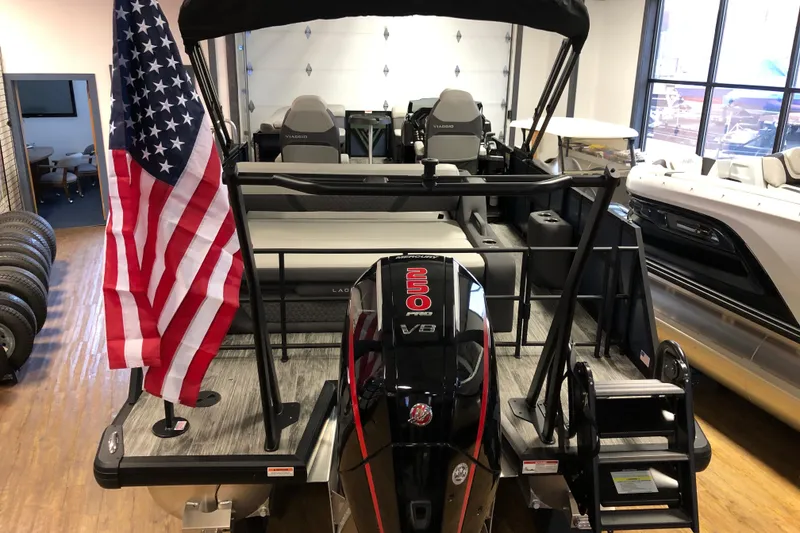 Slide: The Image of 2026 Viaggio Z24S pontoon boat with American flag and powerful outboard motor. - 4