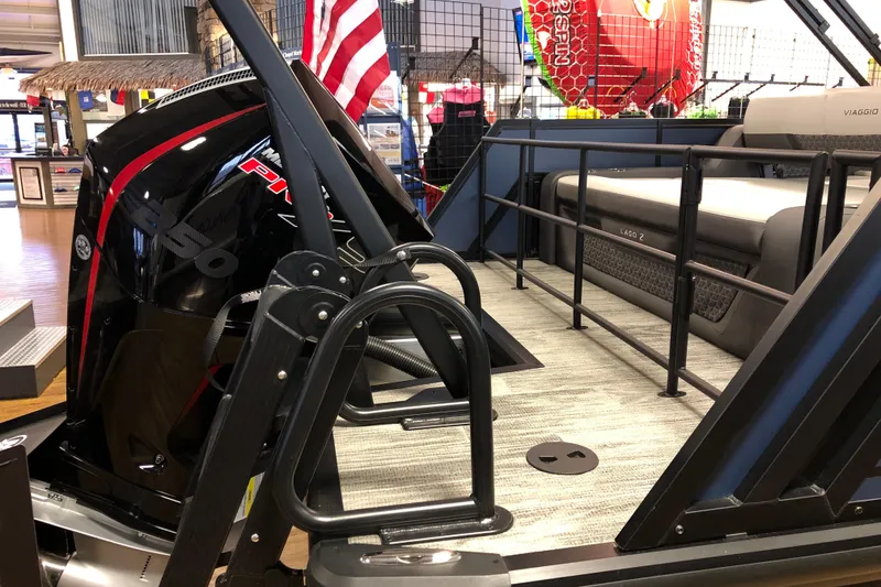 Slide: The Image of 2026 Viaggio Z24S pontoon boat interior with powerful outboard motor and seating. - 5