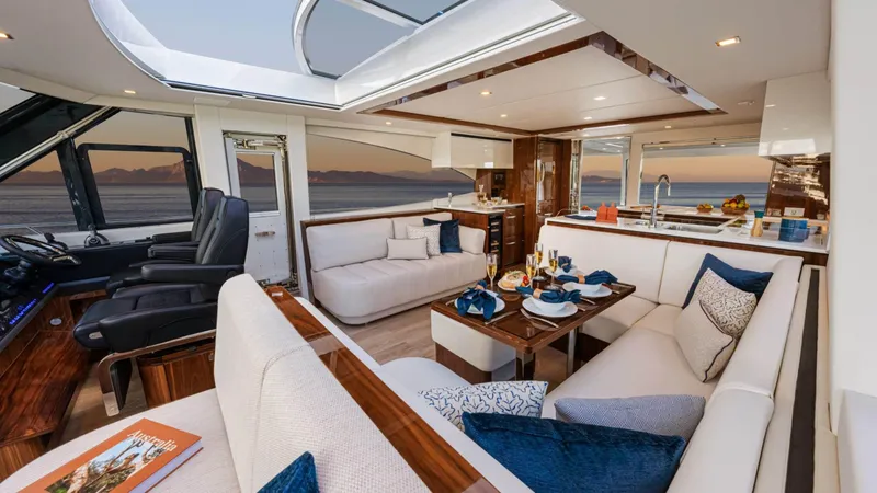 Slide: The Image of Luxurious interior of 2025 Riviera 6800 Sport Yacht Platinum Edition with elegant seating and dining area. - 21
