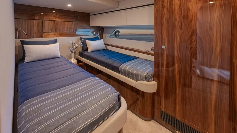 Slide: The Image of Luxurious twin cabin in 2025 Riviera 6800 Sport Yacht Platinum Edition. - 32