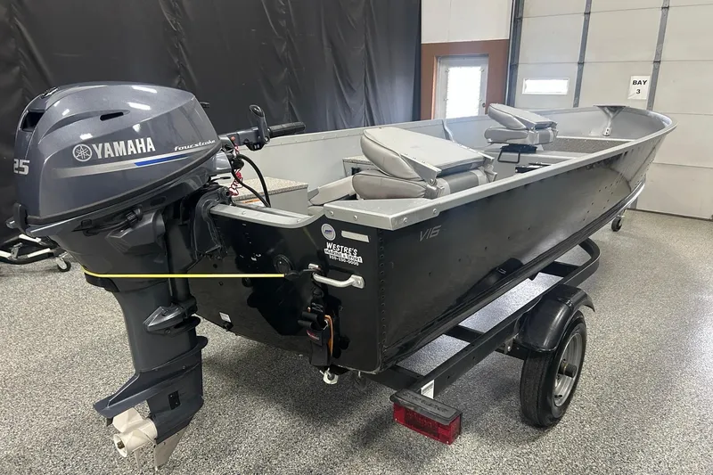 Slide: The Image of 2024 Alumacraft V16 boat with Yamaha 25 outboard motor in a garage setting. - 4