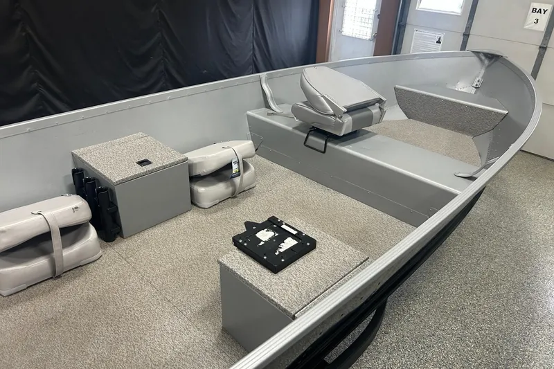 Slide: The Image of 2024 Alumacraft V16 boat interior with seating and storage compartments. - 6