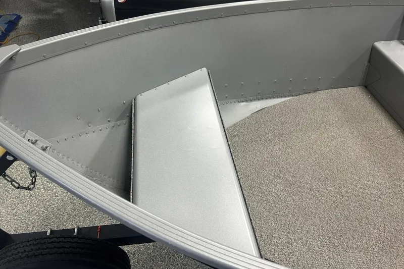 Slide: The Image of 2024 Alumacraft V16 boat interior with gray seating and carpeted floor. - 7