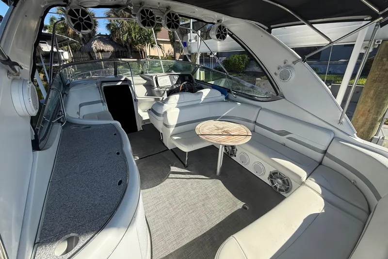 Slide: The Image of 2004 Formula 370 Super Sport boat interior with seating and table, featuring modern design elements. - 13