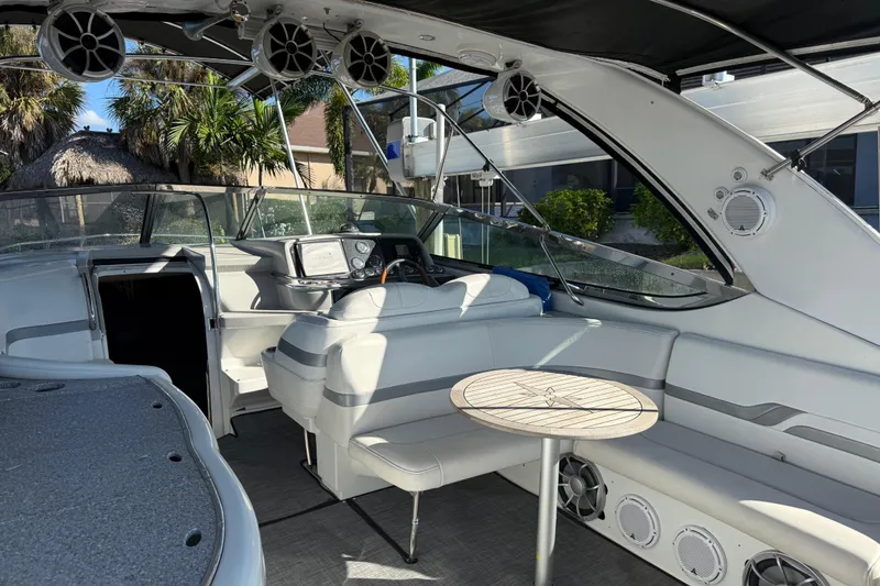 Slide: The Image of 2004 Formula 370 Super Sport boat interior with seating, table, and dashboard. - 16